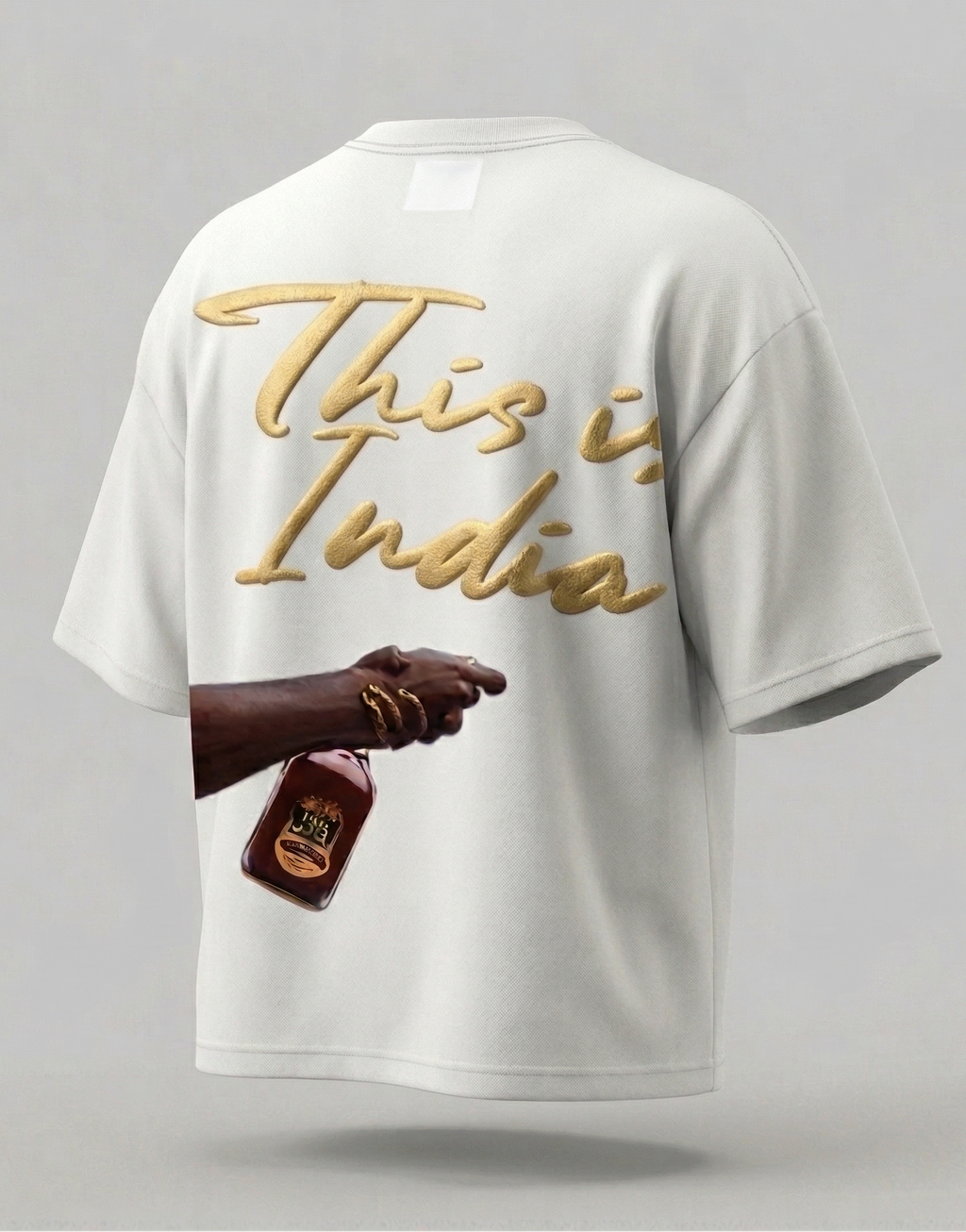 White t-shirt with 'This is India' text and a hand holding a bottle on a gray background